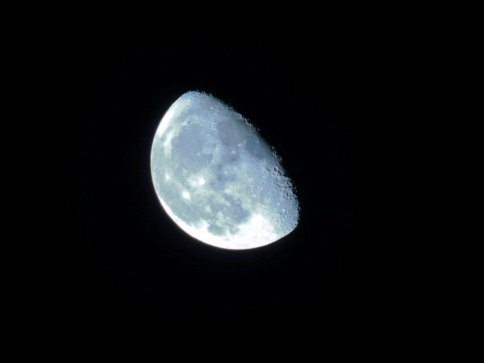 part of the moon on a black sky