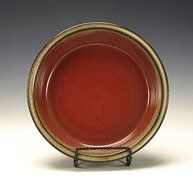 Stoneware pie plate. Iron red and cream.
