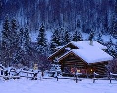 wooden houses on a mountainside in winter