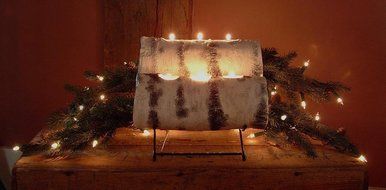 Two tier birch yule log cradle with birch logs and prelit evergreen boughs N2