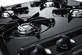 TNL03P 24" wide cooktop in black, with four burners and battery start ignition N2