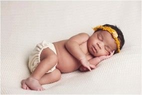 Black skin Newborn Baby Girl sleeps on her side