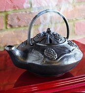 Cast Iron Wood Stove Kettle Steamer with Pine Cone Design, In Black