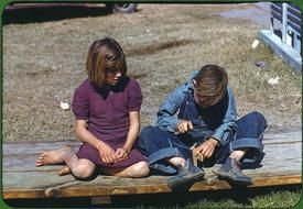children sit on wooden boards