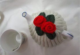 Hand knitted Cream tea cosy with red flowers fits a 4 - 6 cup tea pot N2