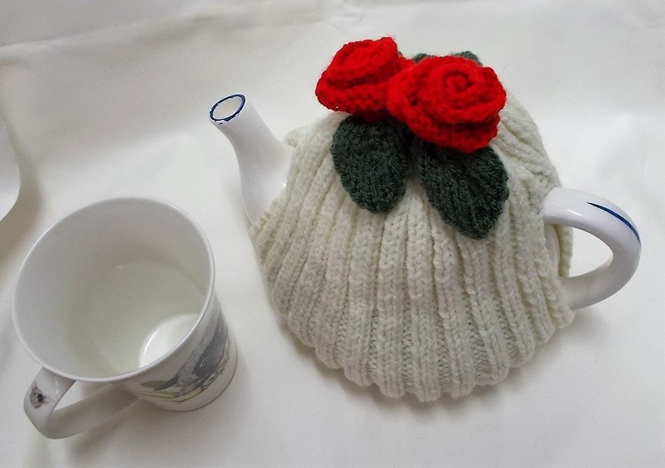 Hand knitted Cream tea cosy with red flowers fits a 4 - 6 cup tea pot