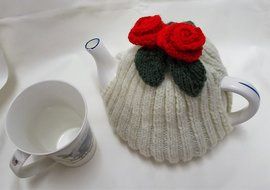 Hand knitted Cream tea cosy with red flowers fits a 4 - 6 cup tea pot N3