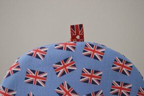 Small Insulated Artisanal Tea Cozy With Union Jacks on Pale Blue Background - Last Cozy