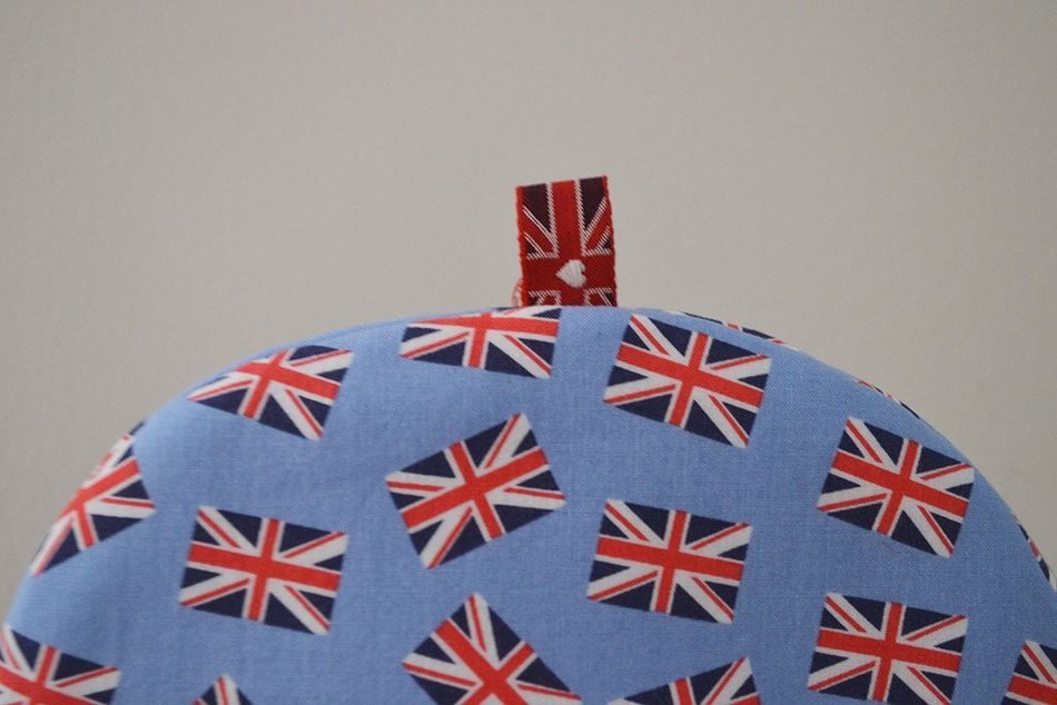 Small Insulated Artisanal Tea Cozy With Union Jacks on Pale Blue Background - Last Cozy