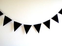 black triangular flags at white background
