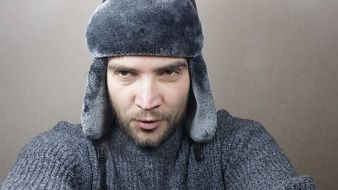 man in hat with ear flaps