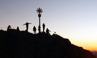 people on the top of mountain at sunset