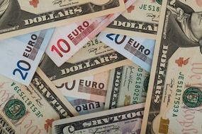 banknotes of american dollars and euro