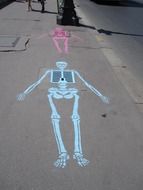 skeleton sewer chalk art