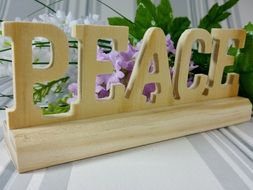 wooden peace decoration with flowers