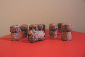 champagne corks on a red table