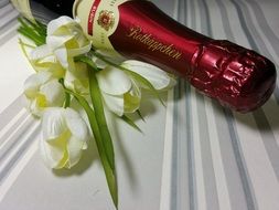 champagne bottle and a romantic bouquet of tulips