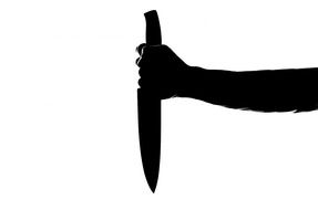 silhouette of a hand with knife