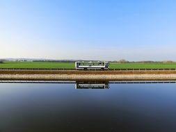 bus riverside sky mirroring