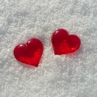 two glass hearts in the snow