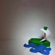 green toy sailing boat