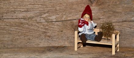 wichtel figure on the wooden bench