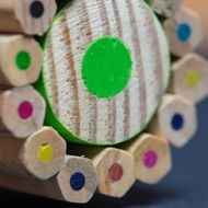 School pencils of different colors with one big green pencil
