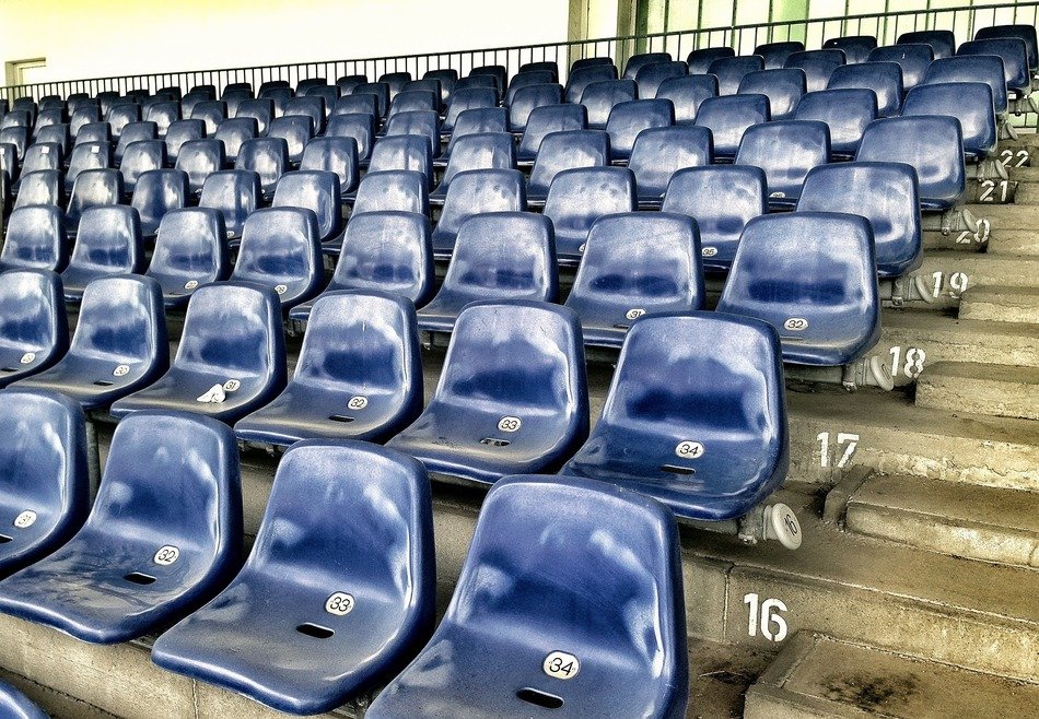 blue seats in the stands of the stadium
