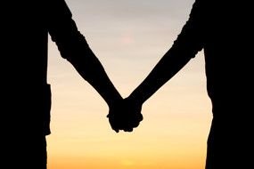 silhouette of the hands of two people as a picture for clipart