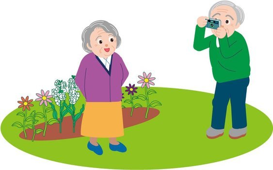picture husband photographs his wife near the flowerbed