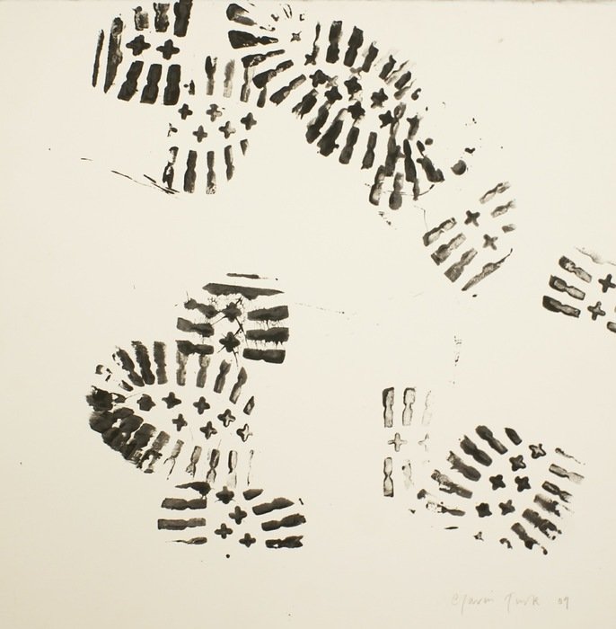 Black footprints from the boots on the ground
