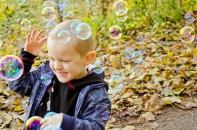 young boy playing with soap bubbles