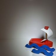 red toy sailing boat