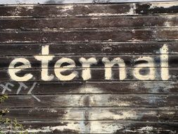 eternal sign wood background old