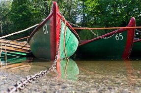 green wooden boats on a river