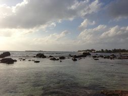 red beach in Saipan on the background of the cloudy sky