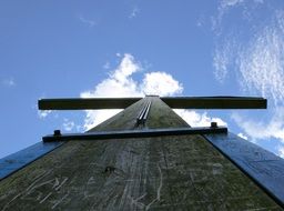 bottom view on wooden cross against the sky