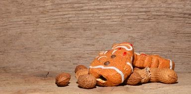 figures of snowmen figure gingerbread man peanuts wood texture background