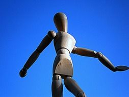sculpture of doll on the background of blue sky