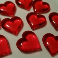 red glass hearts on a white background