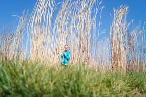 woman and huge dried grass