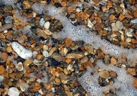 stones pebbles sea water seaside