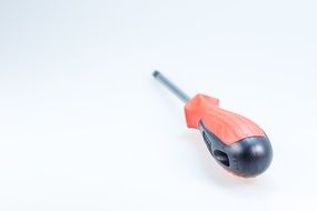 screwdriver with a red and black handle