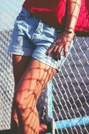 girl in jeans shorts at the gate