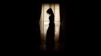 creepy silhoutte of a tall woman in a long dress