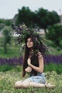 Beautiful woman with big wreath on her head Outdoors