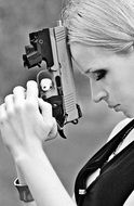 woman praying with a gun in her hand