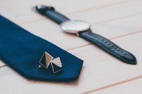 cufflinks and tie lie near the clock