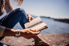 young reading woman on embankment