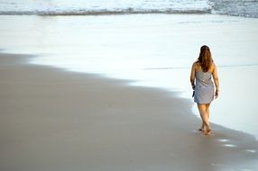 woman on a walk on a sandy beach